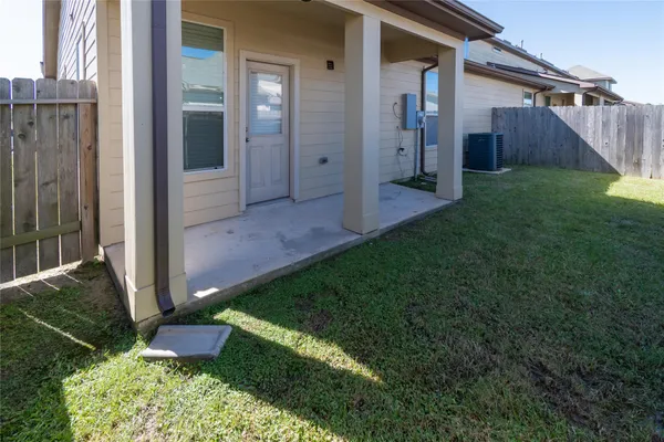a view of backyard with potted plants and wooden fence