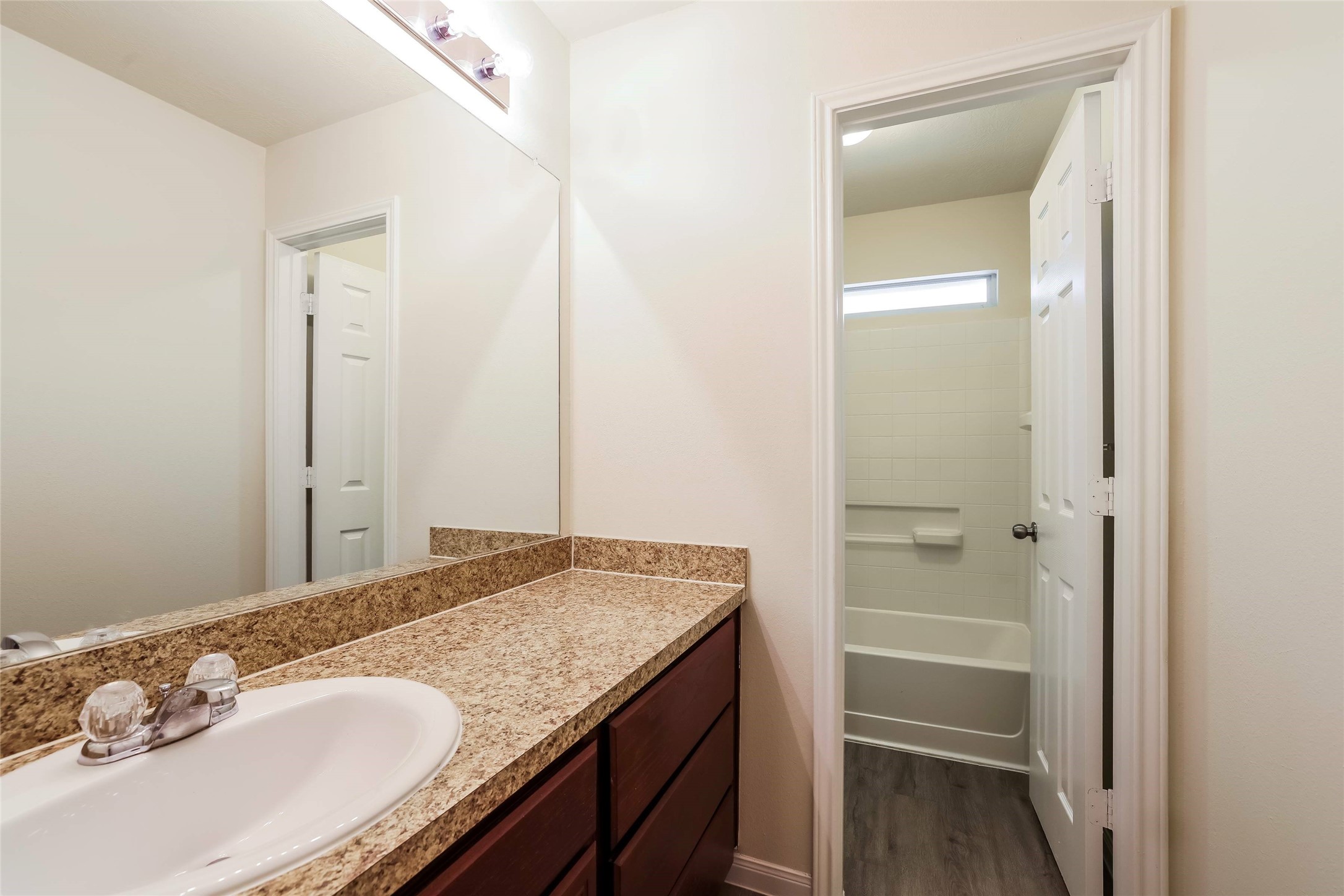 12431 Roy Mix Bohn Lane Houston, TX 77044 - Photo 10 of 13 a bathroom with a granite countertop sink and a mirror