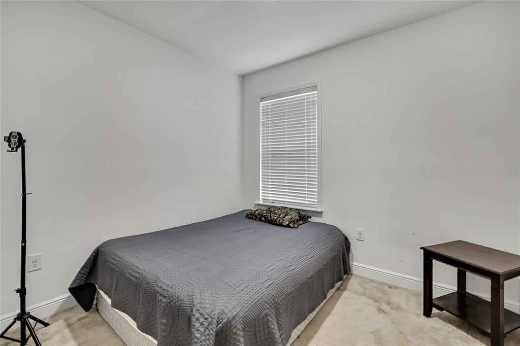 16197 Medrick Road Weeki Wachee, FL 34614 - Photo 15 of 22 a bedroom with a bed and a window