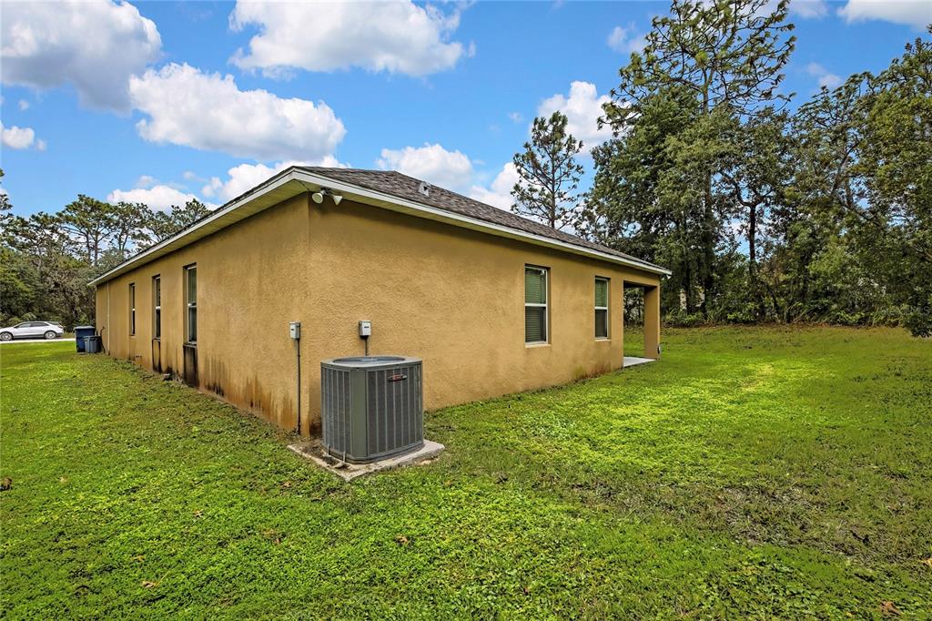 16197 Medrick Road Weeki Wachee, FL 34614 - Photo 22 of 22 a view of a backyard with potted plants and large tree