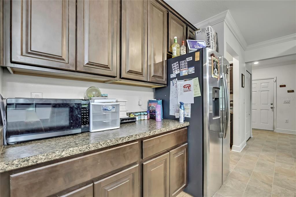 16197 Medrick Road Weeki Wachee, FL 34614 - Photo 4 of 22 a kitchen with stainless steel appliances granite countertop a refrigerator and a stove