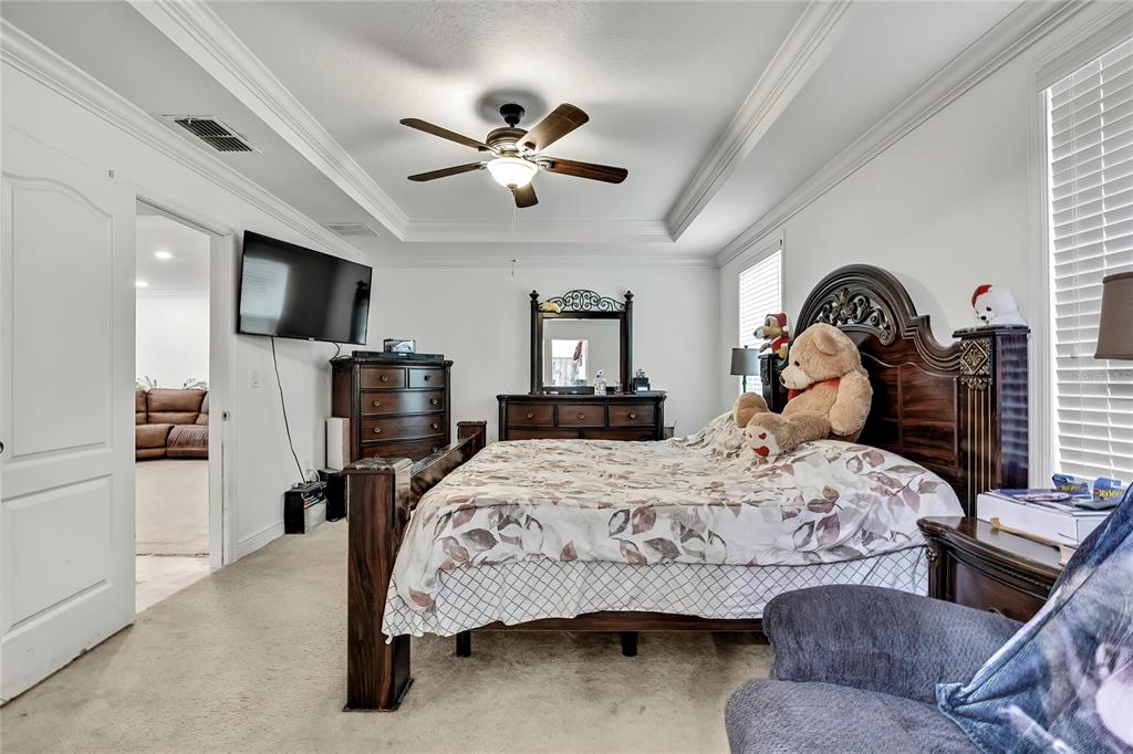 16197 Medrick Road Weeki Wachee, FL 34614 - Photo 8 of 22 a bedroom with a bed and a flat screen tv