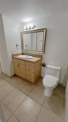 a front view of multi story residential apartment building with yard and space