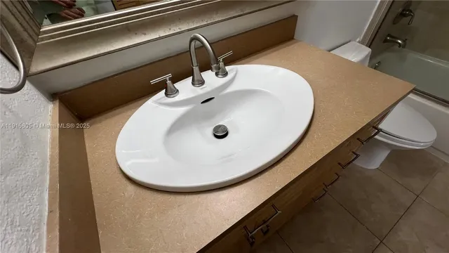 a view of a swimming pool with a garden and palm trees