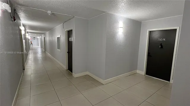 a view of hallway with a bathroom