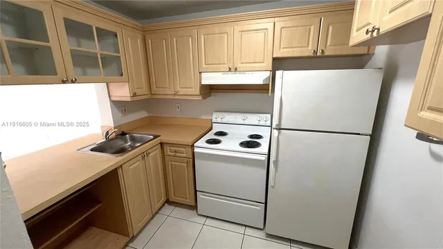 a kitchen with a refrigerator sink stove and cabinets
