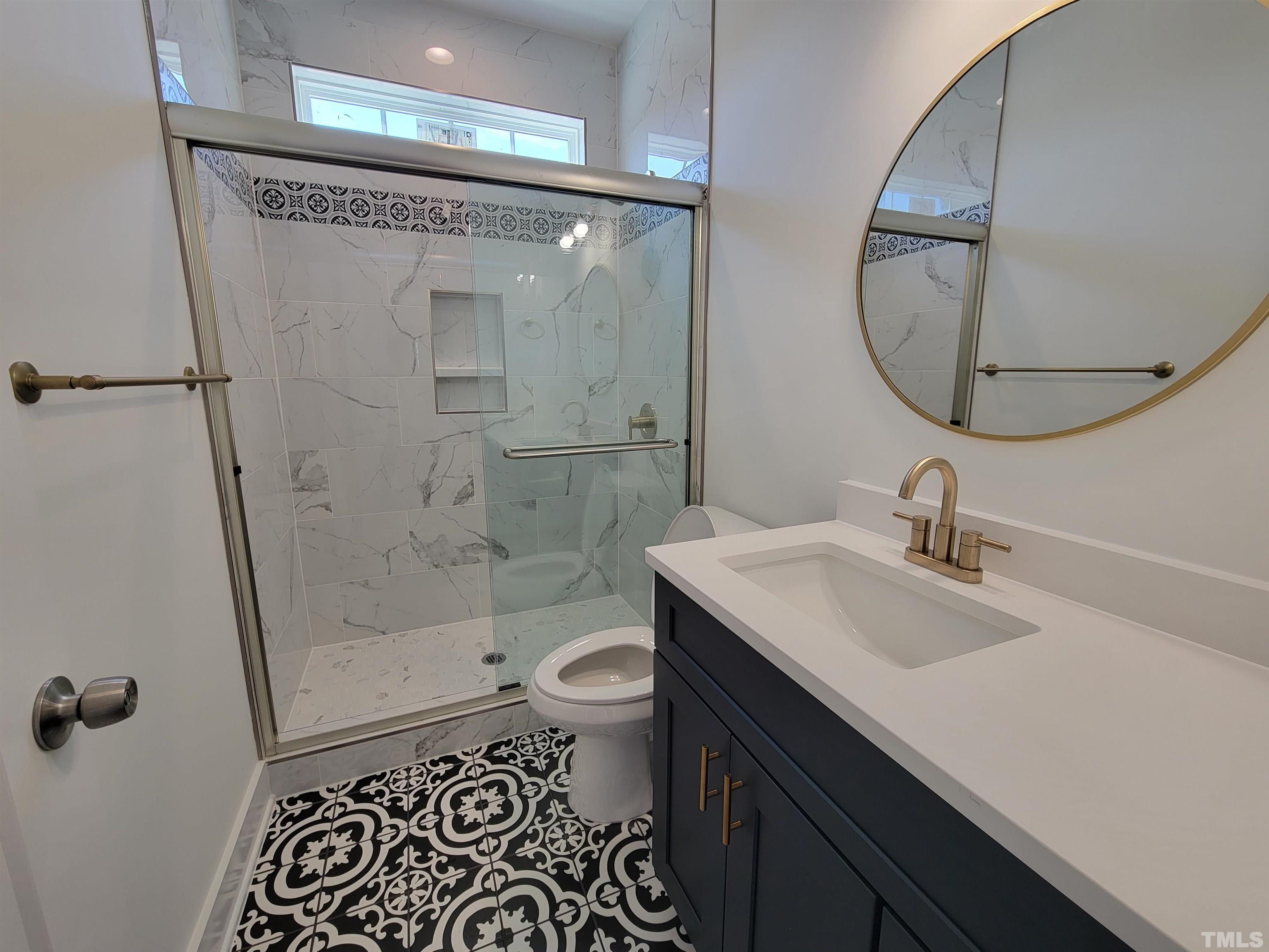 104 Glasgow Street Stem, NC 27581 - Photo 11 of 21 a bathroom with a sink toilet a mirror and shower