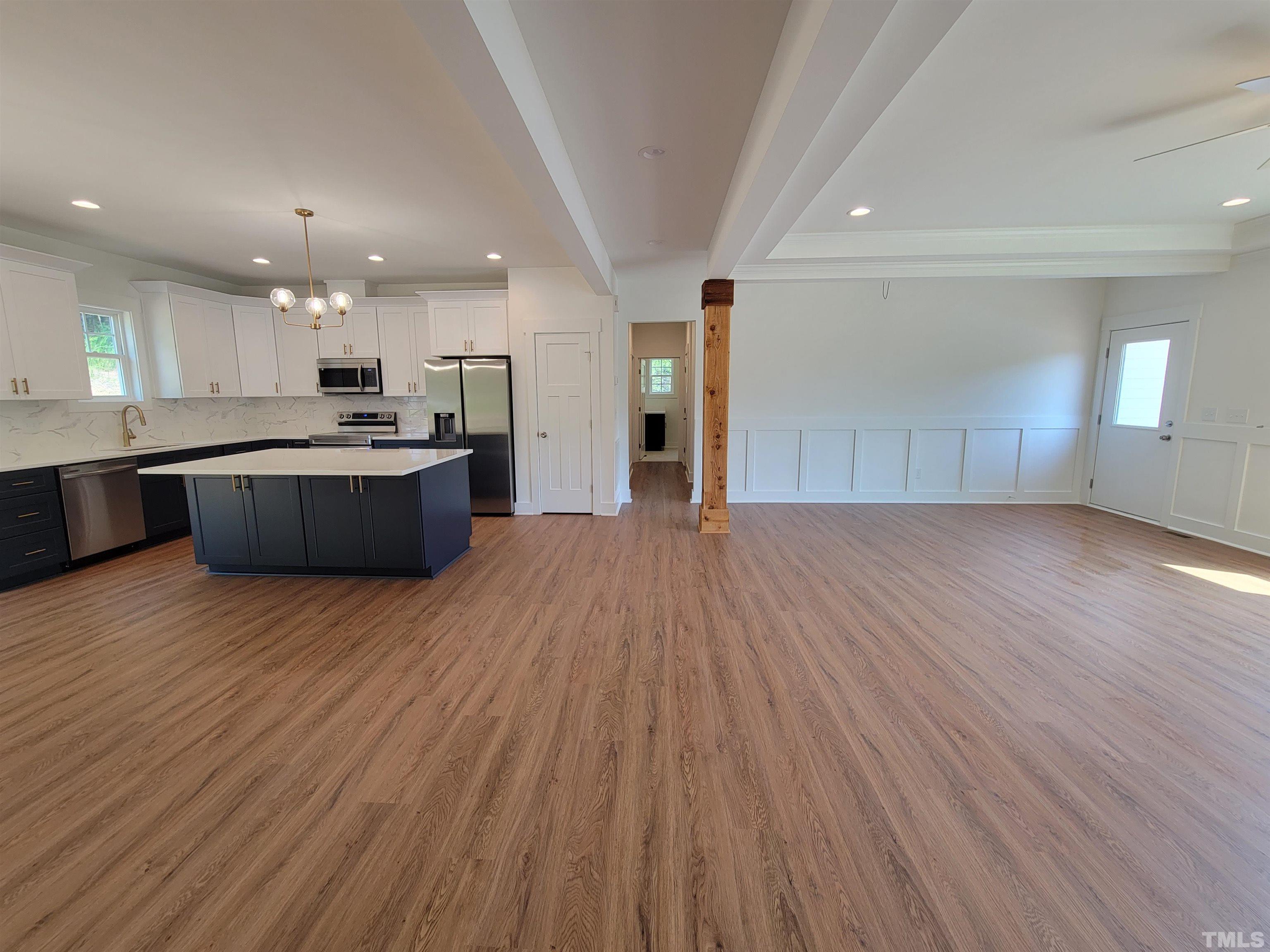 104 Glasgow Street Stem, NC 27581 - Photo 13 of 21 a view of kitchen with kitchen island wooden floor center island and stainless steel appliances