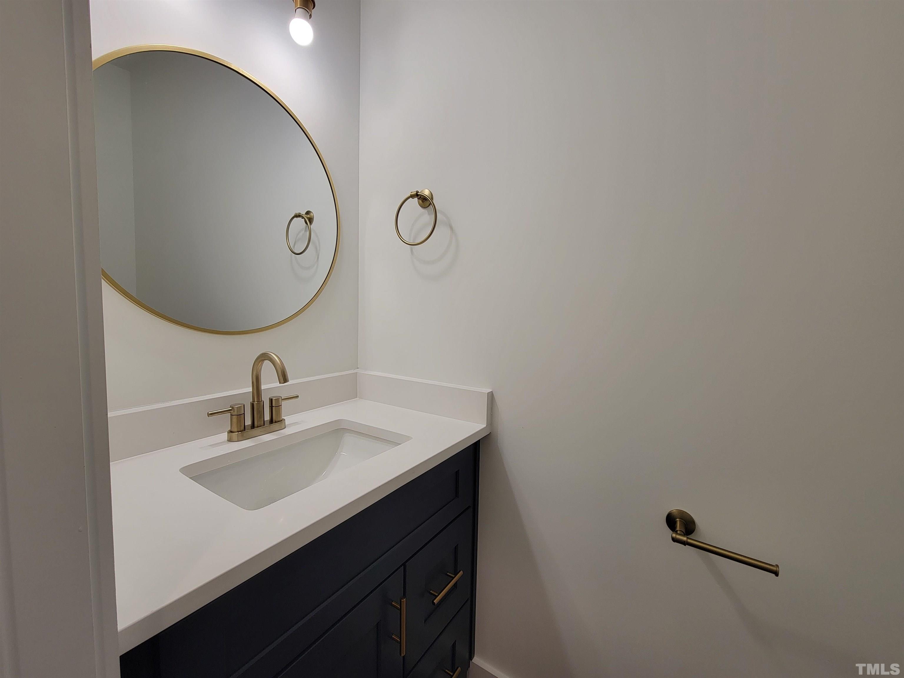 104 Glasgow Street Stem, NC 27581 - Photo 15 of 21 a bathroom with a sink and a mirror