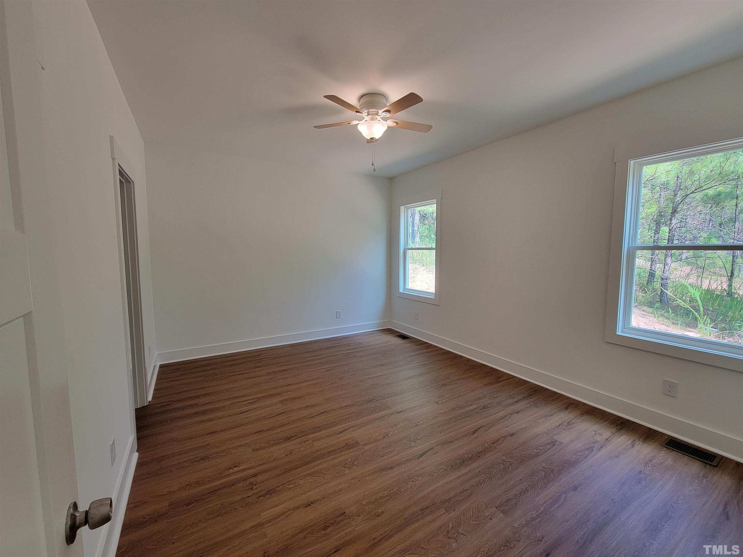 104 Glasgow Street Stem, NC 27581 - Photo 17 of 21 a view of a livingroom with a window and wooden floor