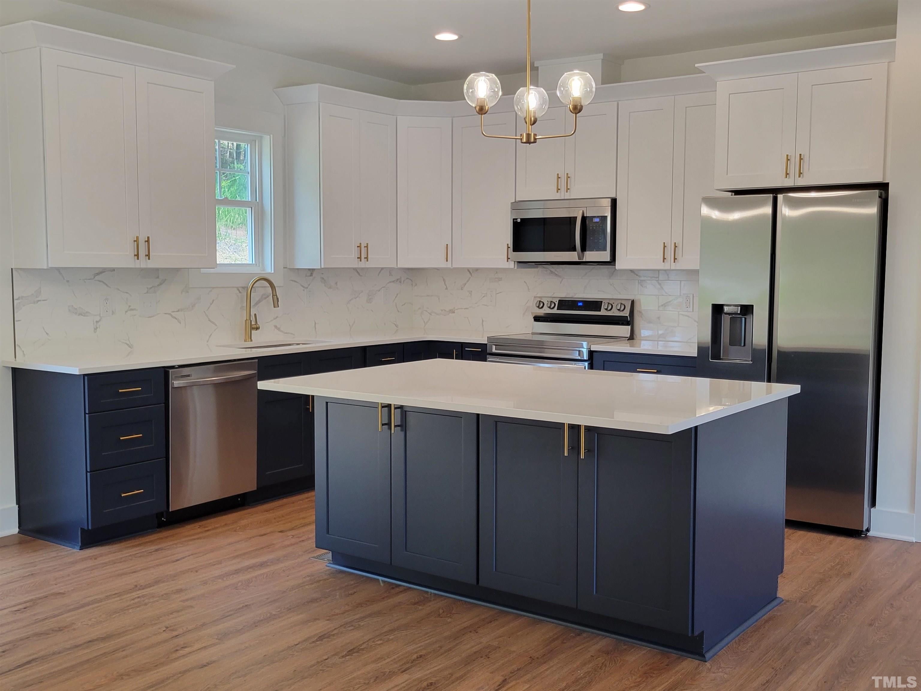 104 Glasgow Street Stem, NC 27581 - Photo 8 of 21 a kitchen with stainless steel appliances a sink stove and refrigerator