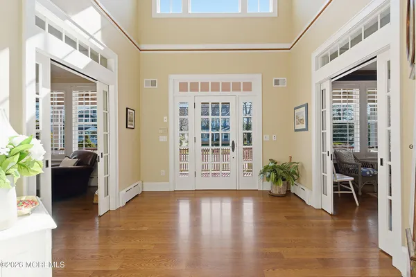 a view of an entryway with wooden floor and a livingroom