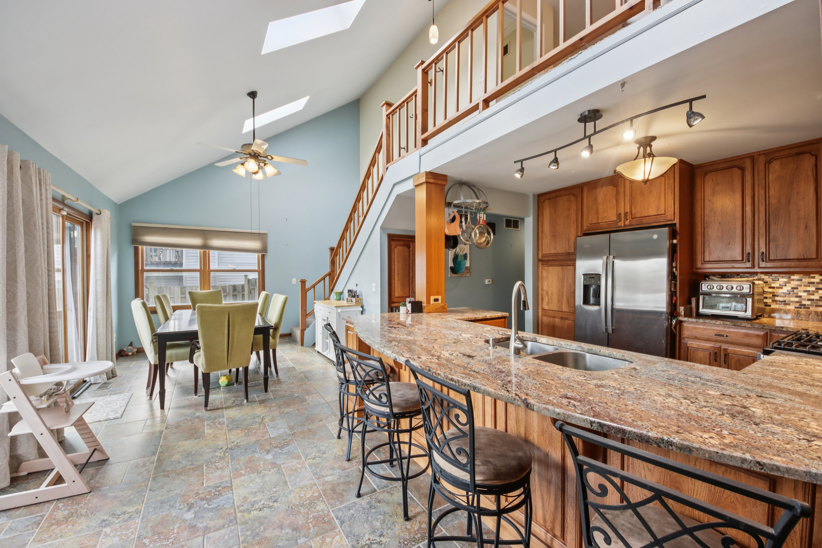 27884 West Riverside Drive Antioch, IL 60002 - Photo 5 of 45 a dining hall with couches a dining table and chairs with wooden floor