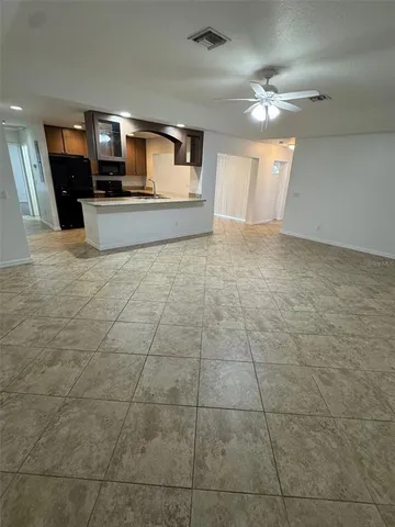 a view of a hallway with a kitchen