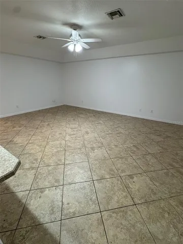 a view of a livingroom with an empty space and a floor to ceiling window