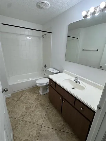 a bathroom with a double vanity sink mirror and toilet