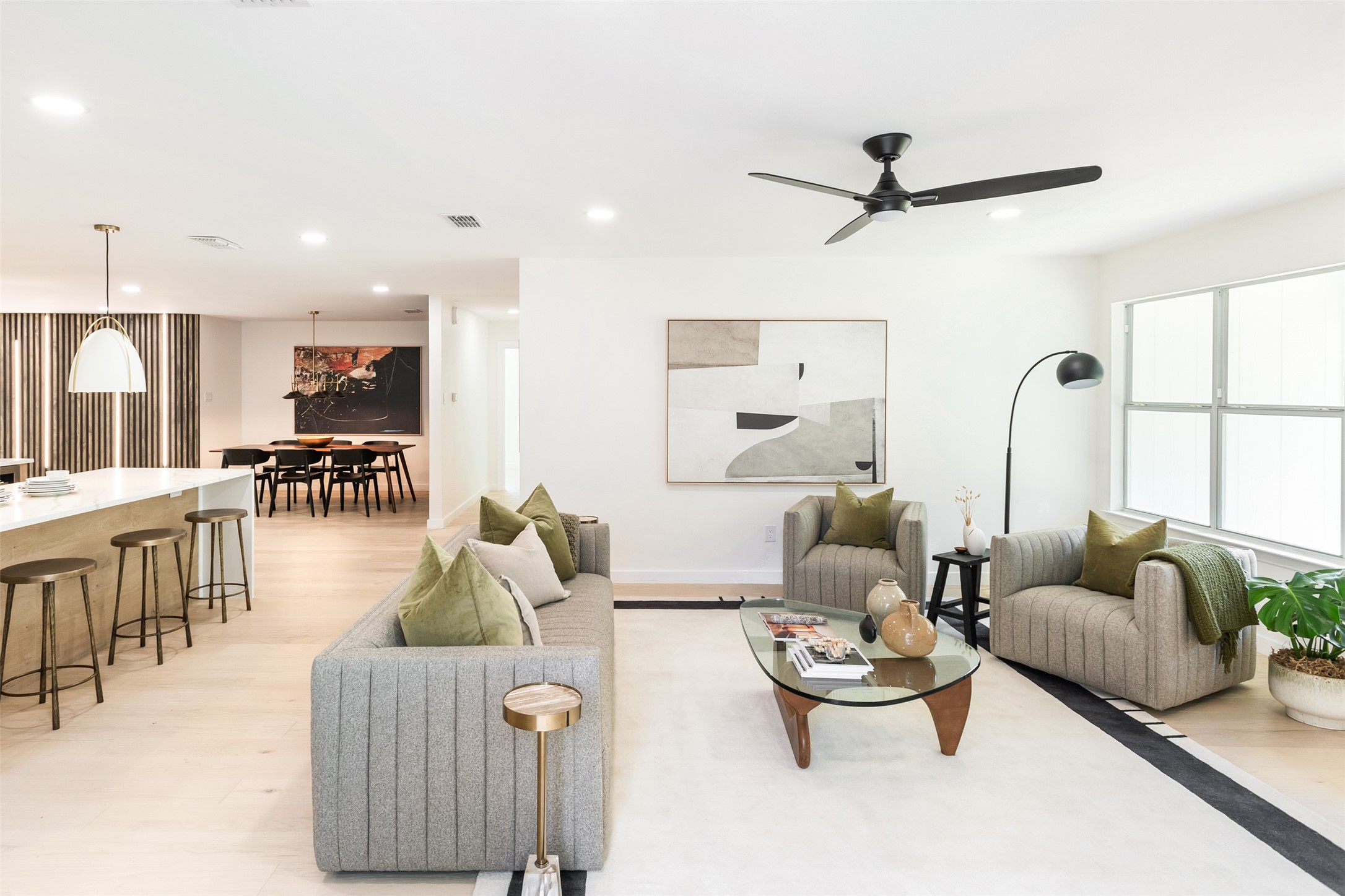 7604 Islander Drive Austin, TX 78749 - Photo 22 of 38 Clean lines define this luminous open-concept living area, flowing seamlessly into the dining space and kitchen island.