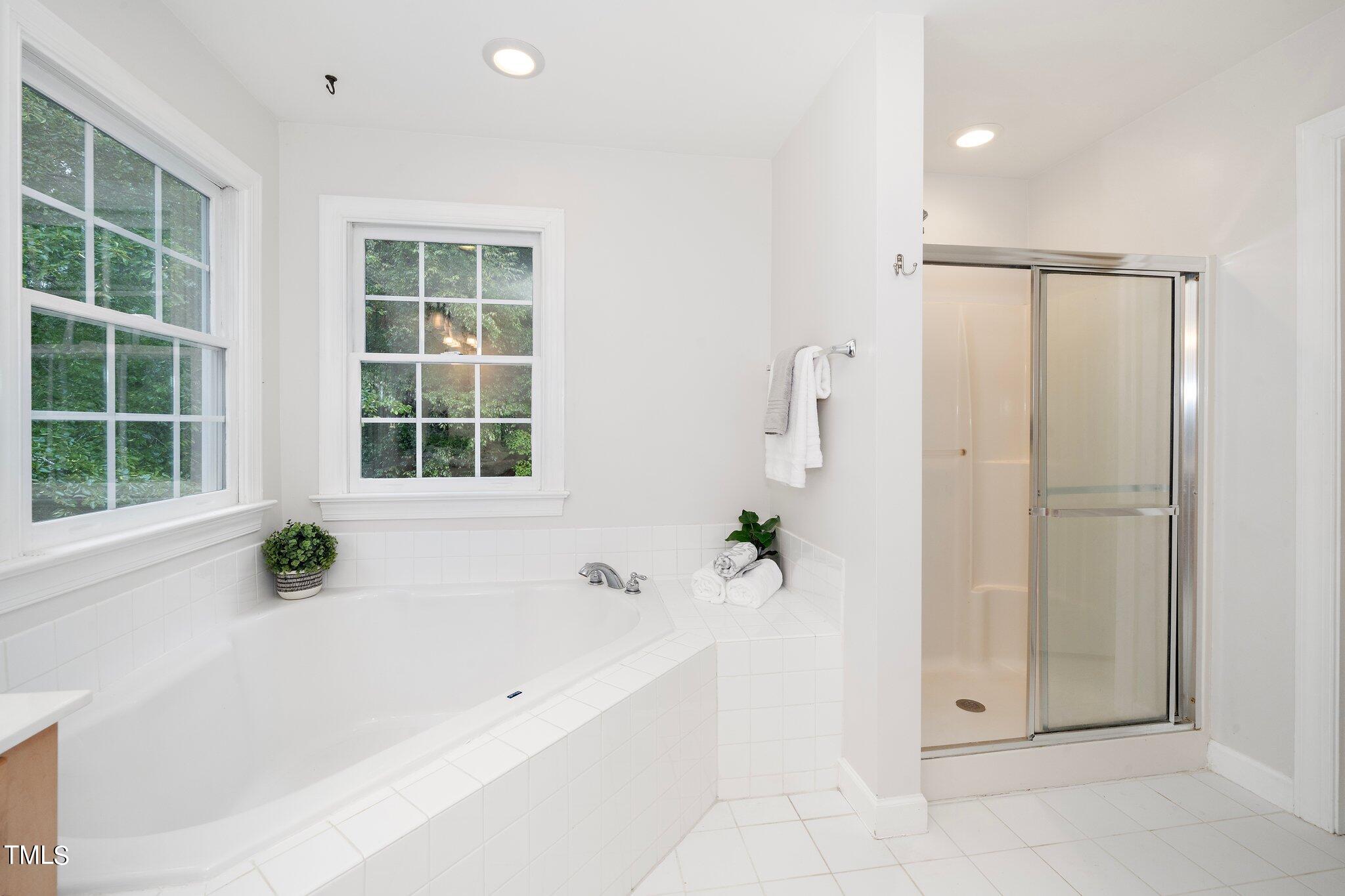 4427 Spring Meadows Road Hillsborough, NC 27278 - Photo 20 of 42 a bathroom with a bathtub and shower