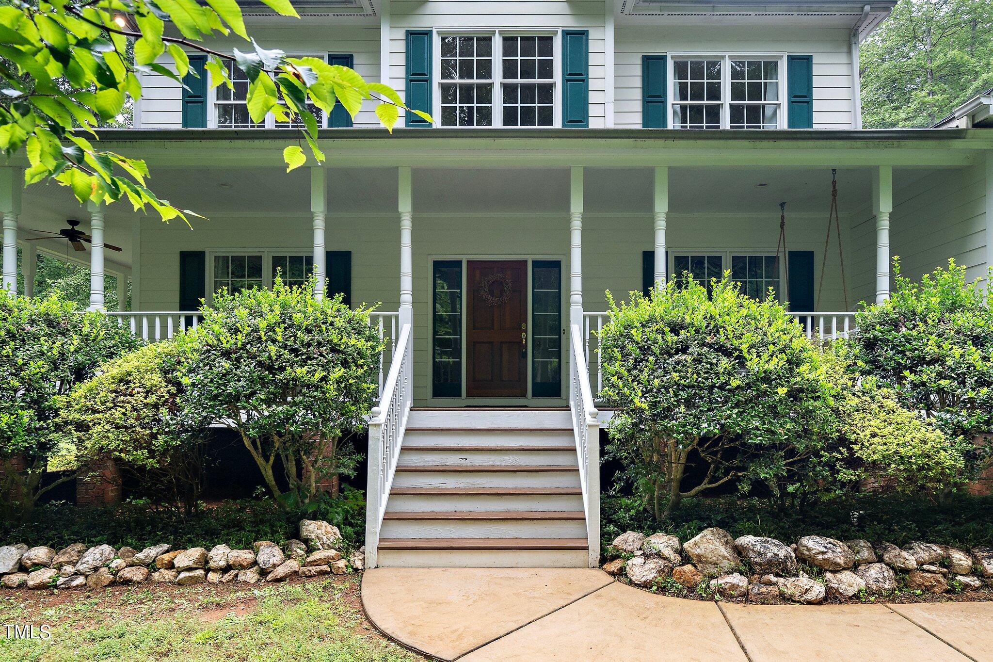 4427 Spring Meadows Road Hillsborough, NC 27278 - Photo 2 of 42 a front view of a house with a garden
