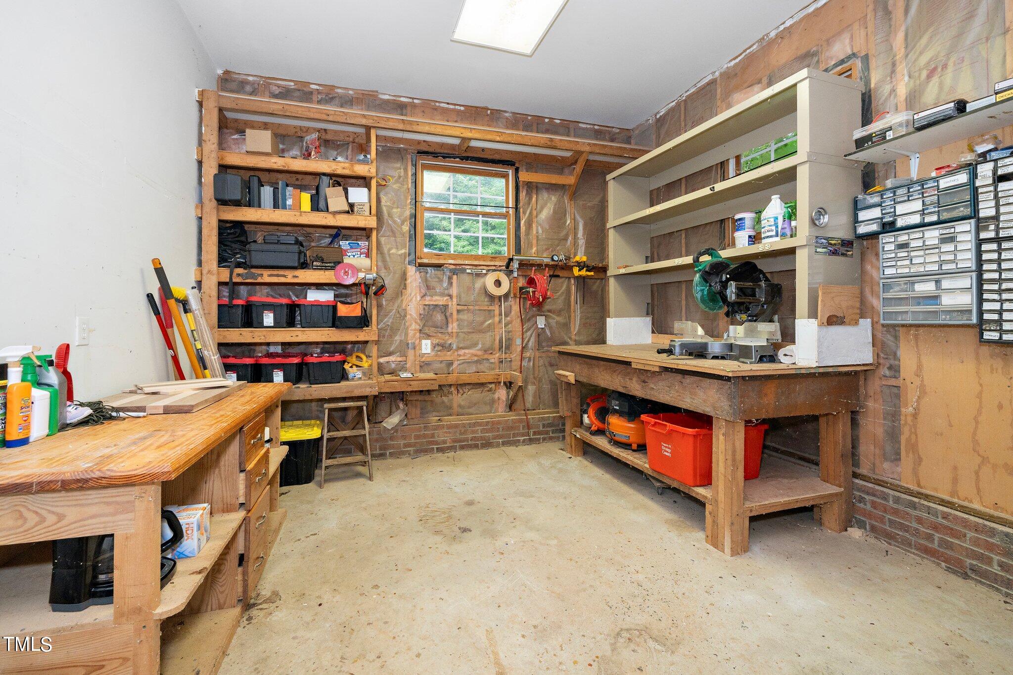 4427 Spring Meadows Road Hillsborough, NC 27278 - Photo 24 of 42 a room with furniture a rug and a book shelf