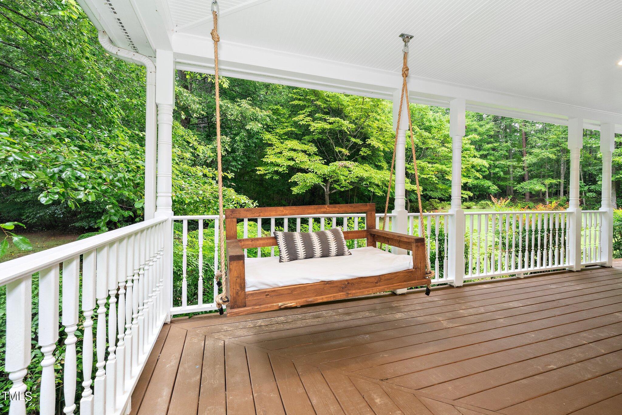 4427 Spring Meadows Road Hillsborough, NC 27278 - Photo 28 of 42 a view of a deck with a floor to ceiling window and wooden floor