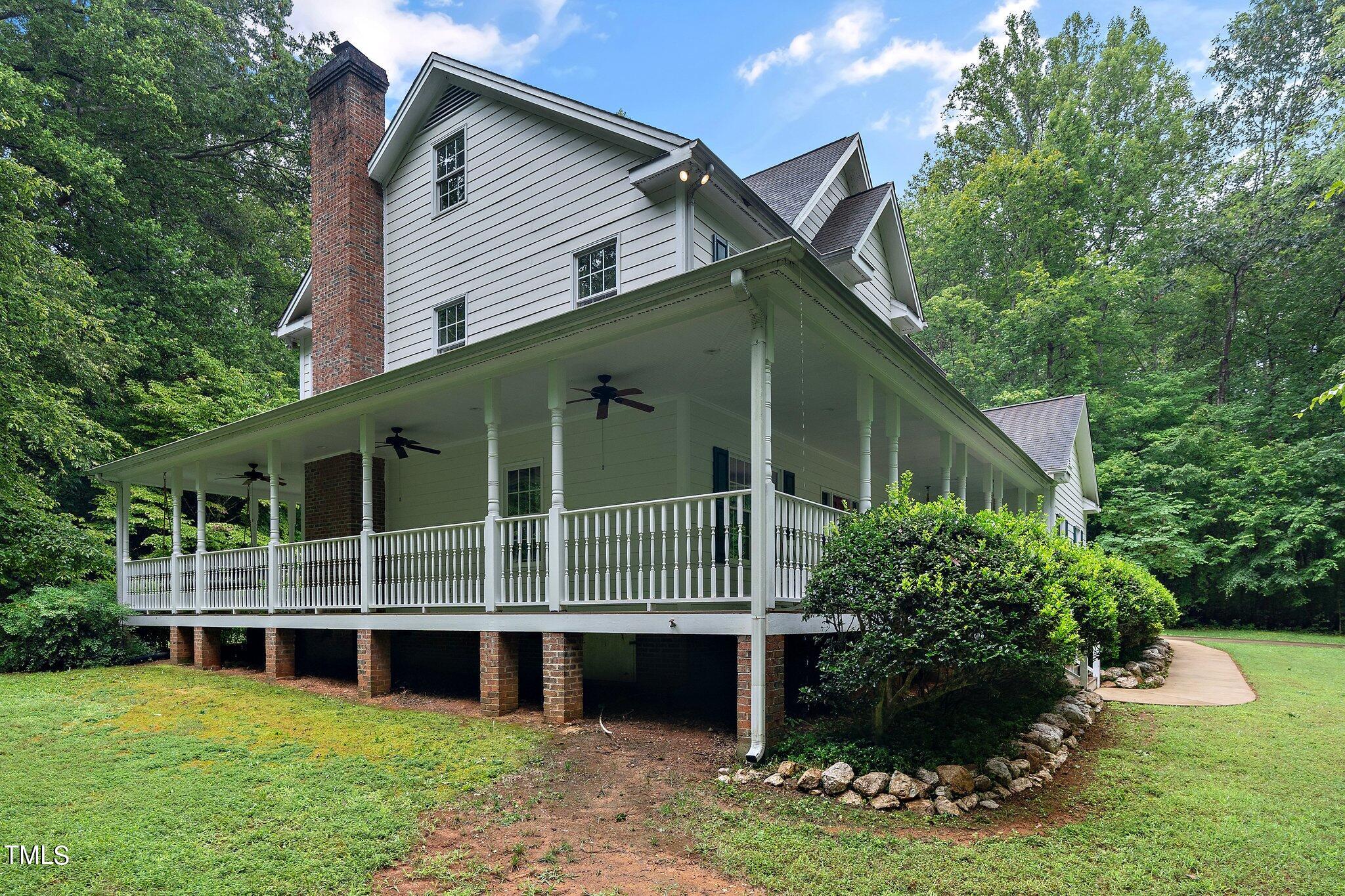4427 Spring Meadows Road Hillsborough, NC 27278 - Photo 3 of 42 a front view of a house with a garden