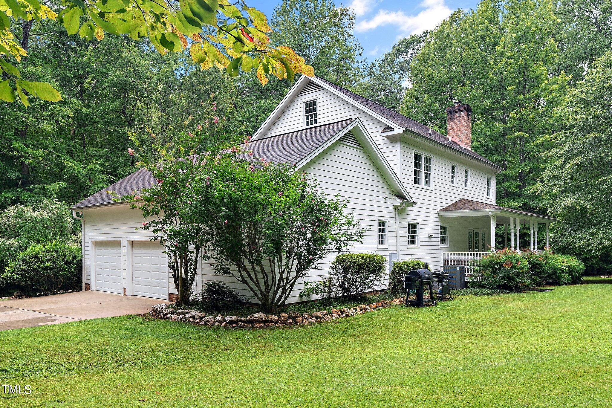 4427 Spring Meadows Road Hillsborough, NC 27278 - Photo 32 of 42 a front view of a house with a garden
