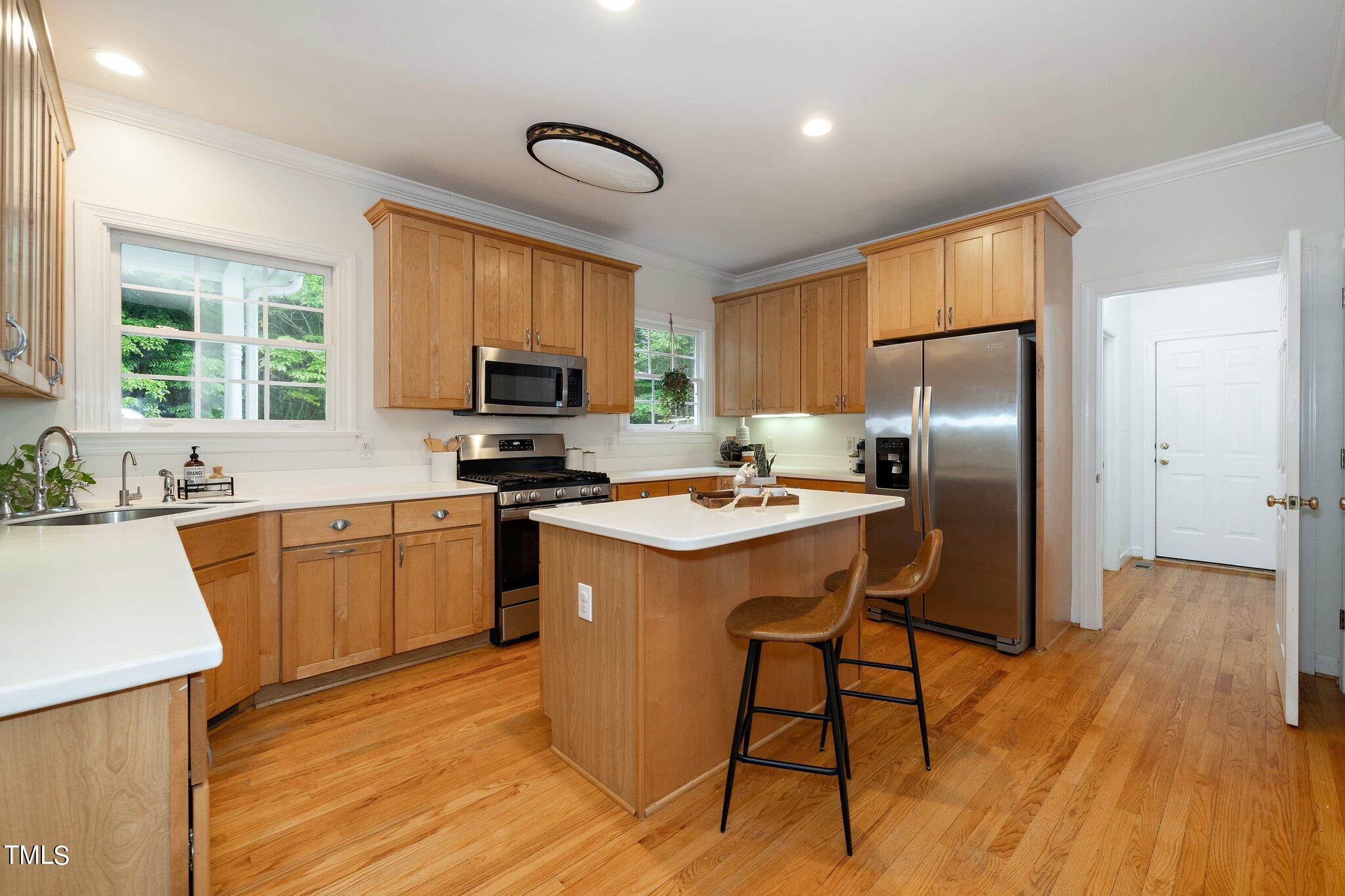 4427 Spring Meadows Road Hillsborough, NC 27278 - Photo 4 of 42 a kitchen with stainless steel appliances granite countertop a refrigerator a stove top oven a sink dishwasher and a refrigerator with wooden floor