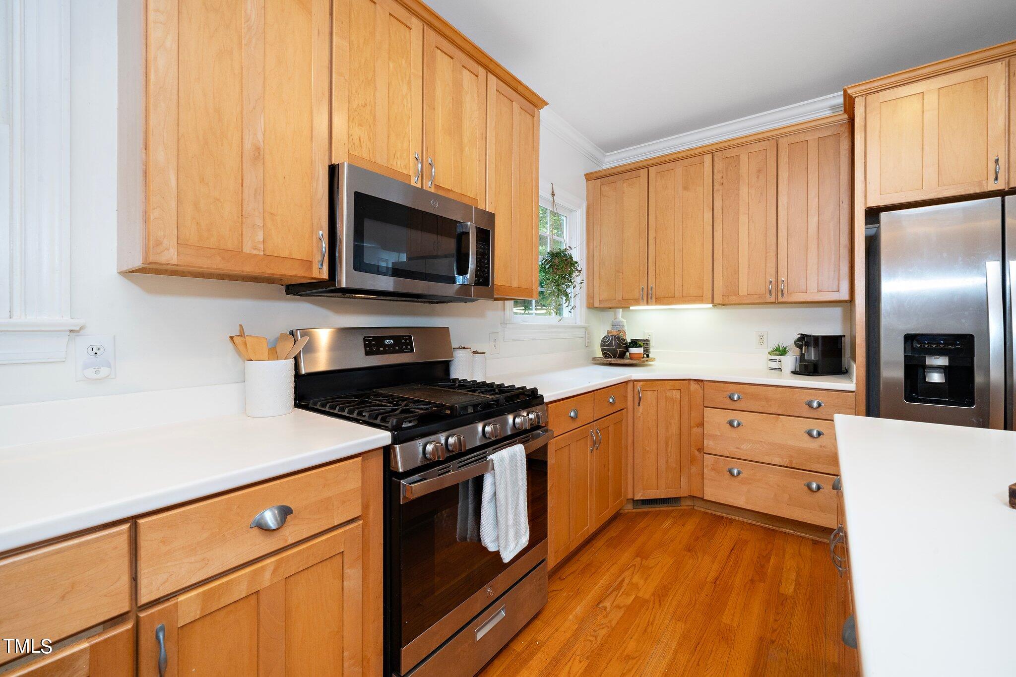 4427 Spring Meadows Road Hillsborough, NC 27278 - Photo 6 of 42 a kitchen with stainless steel appliances granite countertop a stove a sink and a microwave