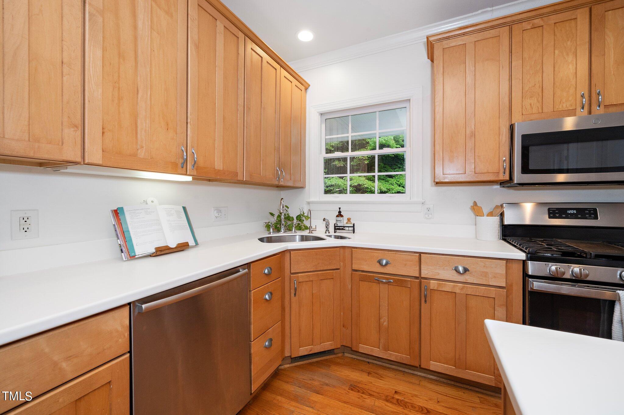 4427 Spring Meadows Road Hillsborough, NC 27278 - Photo 7 of 42 a kitchen with granite countertop wooden cabinets a sink and a stove
