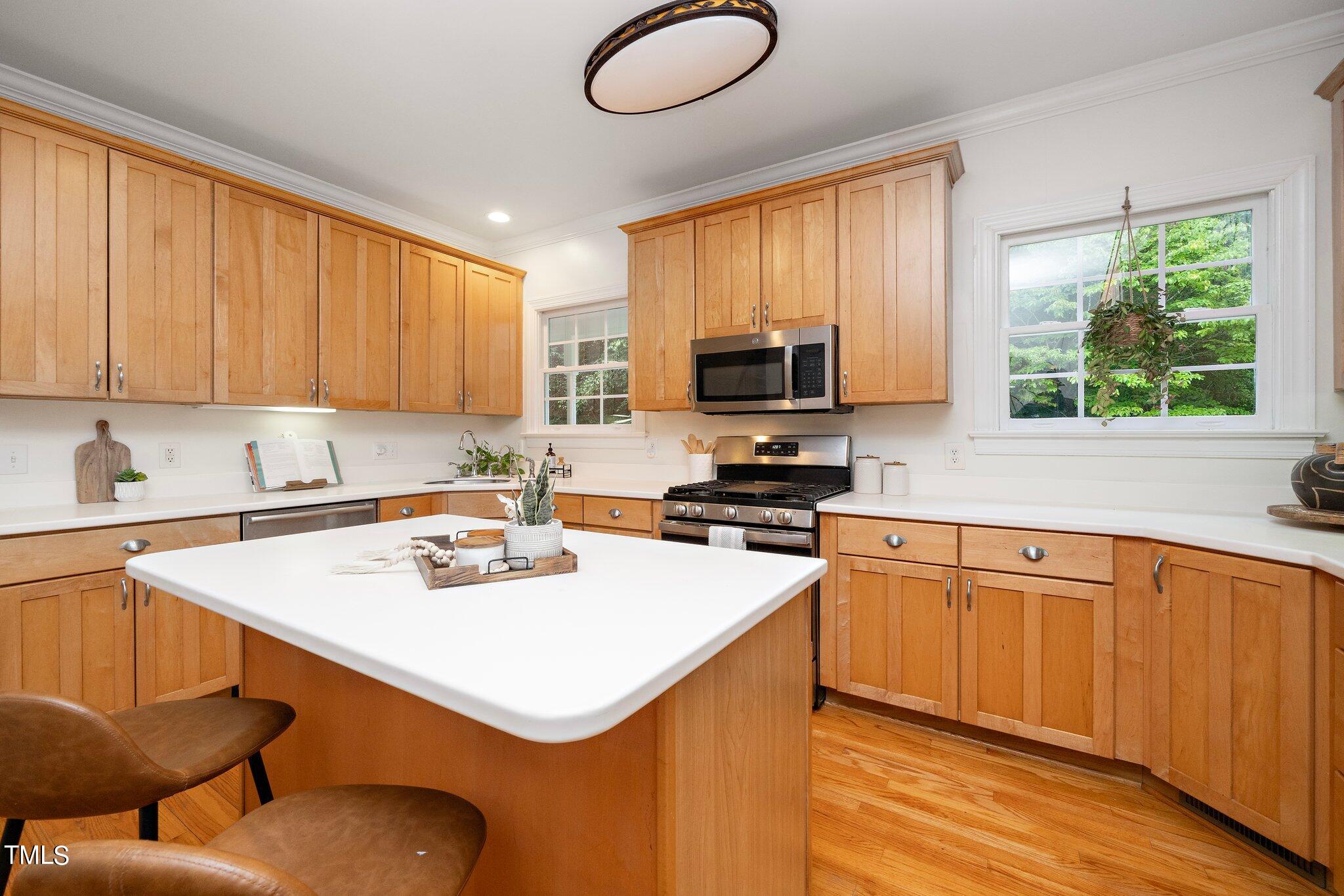 4427 Spring Meadows Road Hillsborough, NC 27278 - Photo 8 of 42 a kitchen with stainless steel appliances granite countertop a sink a stove and a refrigerator