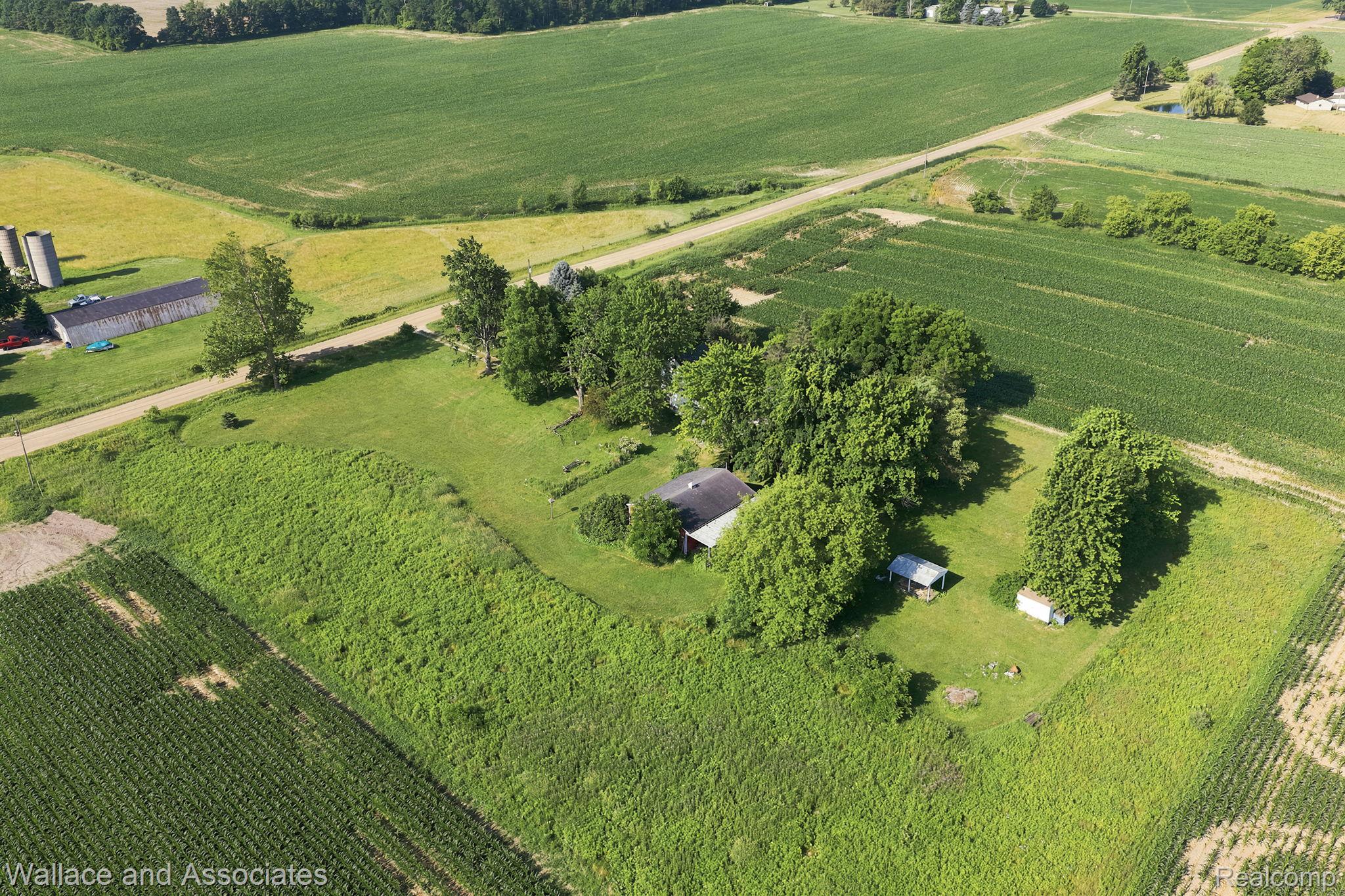 5949 Roach Road Croswell, MI 48422 - Photo 45 of 48 Expansive rural property featuring a main residence, multiple outbuildings, and mature trees