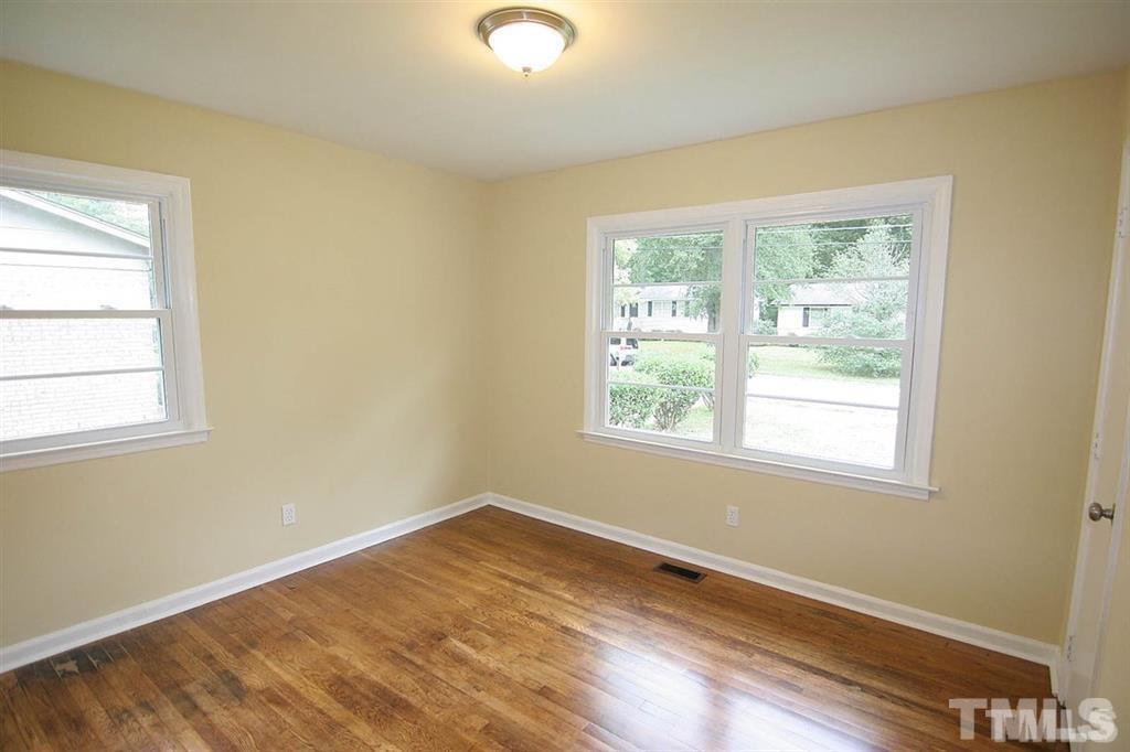556 Dacian Road Raleigh, NC 27610 - Photo 11 of 20 a view of a room with wooden floor and windows