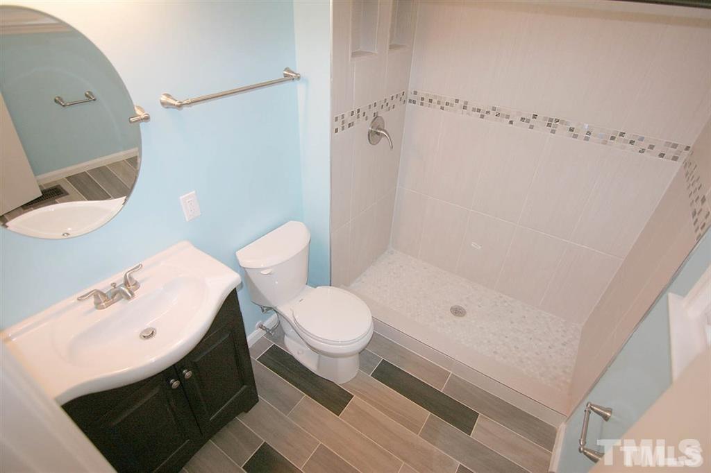 556 Dacian Road Raleigh, NC 27610 - Photo 14 of 20 a bathroom with a toilet sink and shower