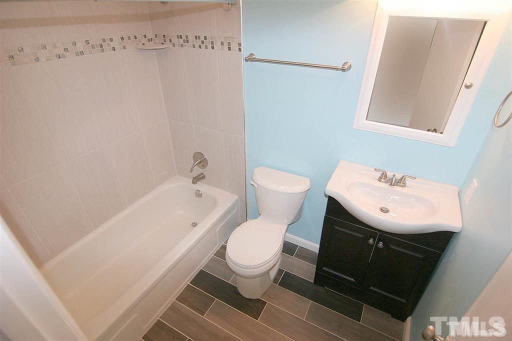 556 Dacian Road Raleigh, NC 27610 - Photo 15 of 20 a white toilet sitting next to a bathroom sink
