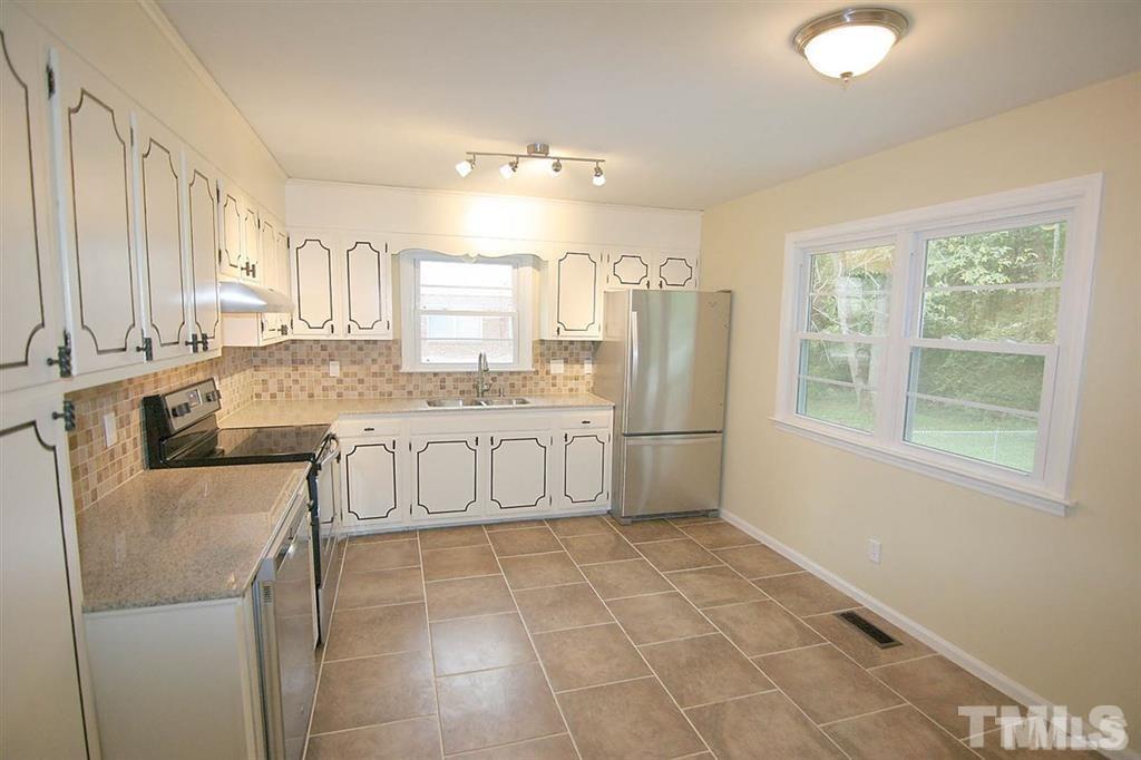 556 Dacian Road Raleigh, NC 27610 - Photo 7 of 20 a large white kitchen with a large window