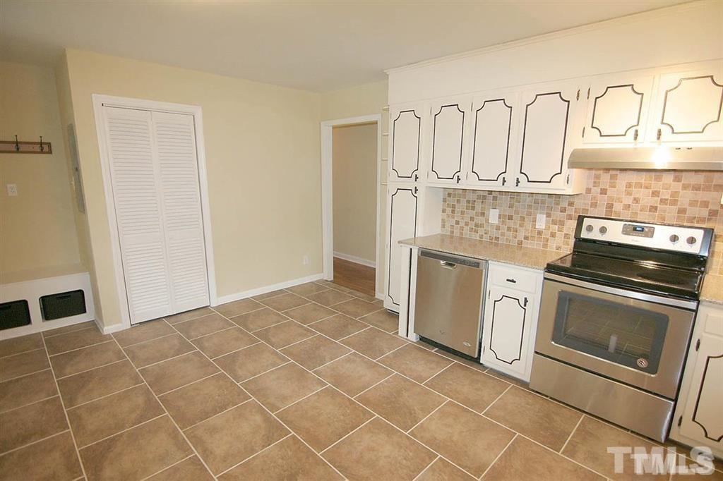 556 Dacian Road Raleigh, NC 27610 - Photo 8 of 20 a kitchen with granite countertop a sink cabinets and stainless steel appliances