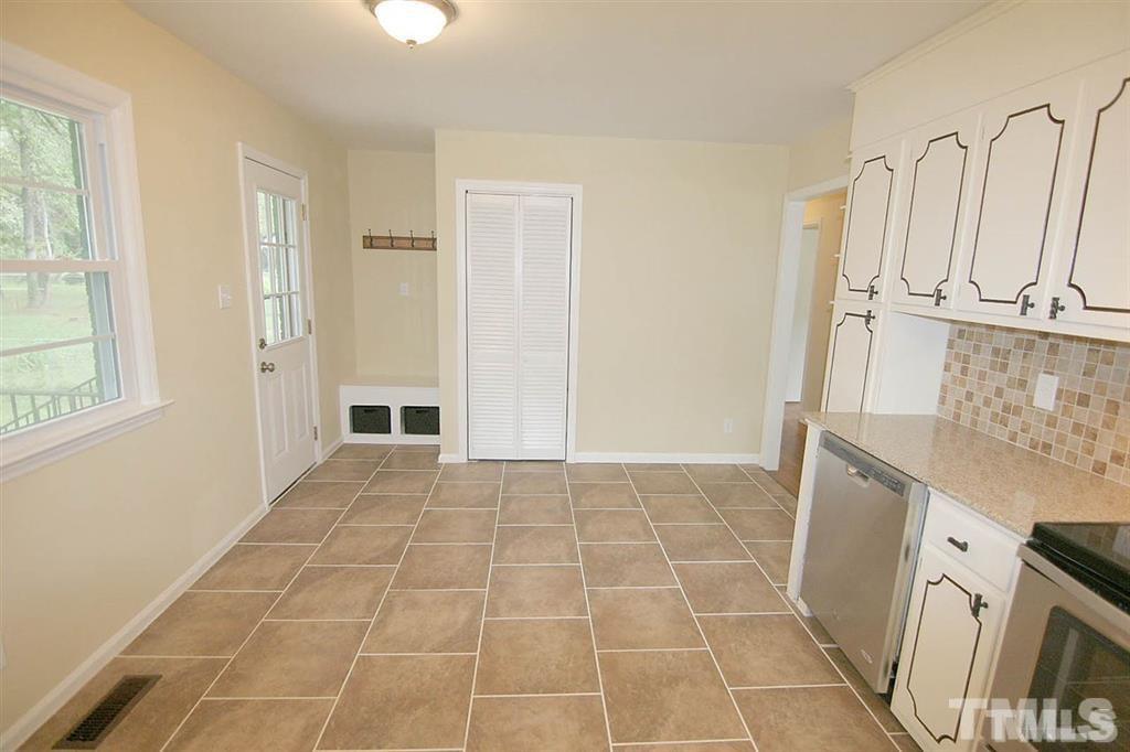 556 Dacian Road Raleigh, NC 27610 - Photo 9 of 20 a view of a kitchen with white cabinets and sink