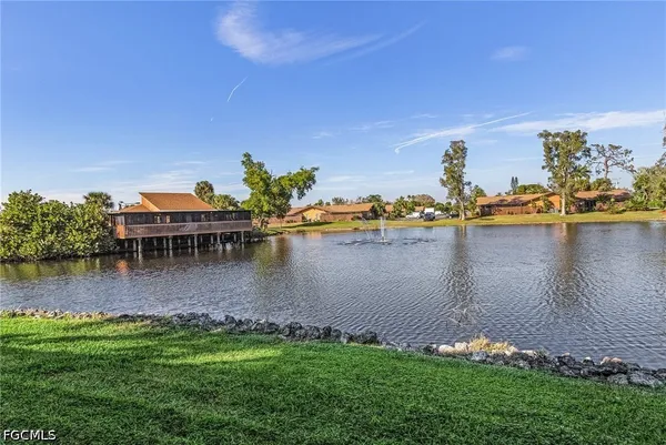 a view of a lake with houses in the back
