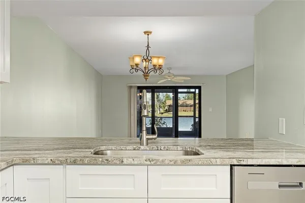 a bathroom with a granite countertop sink and a large mirror