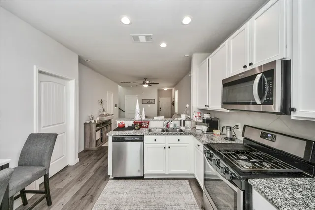a kitchen with a sink stove and cabinets