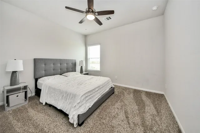 a bedroom with a bed and window