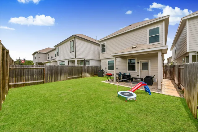 a view of a house with backyard sitting area and swimming pool