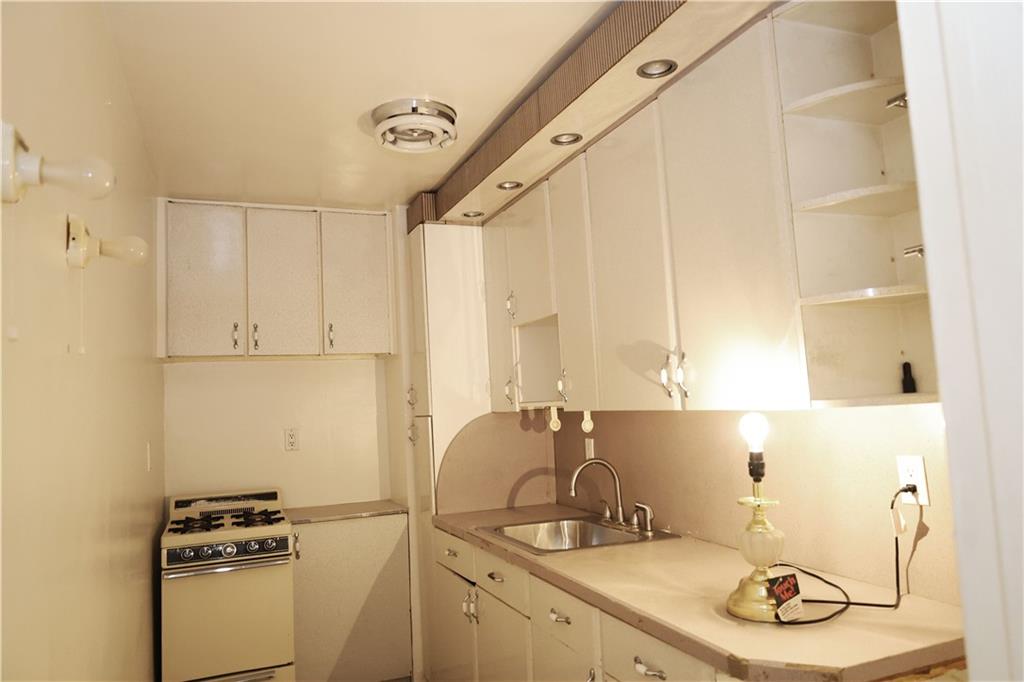 415 Beverley Road, Unit 3J Brooklyn, NY 11218 - Photo 3 of 4 a bathroom with a sink and a mirror