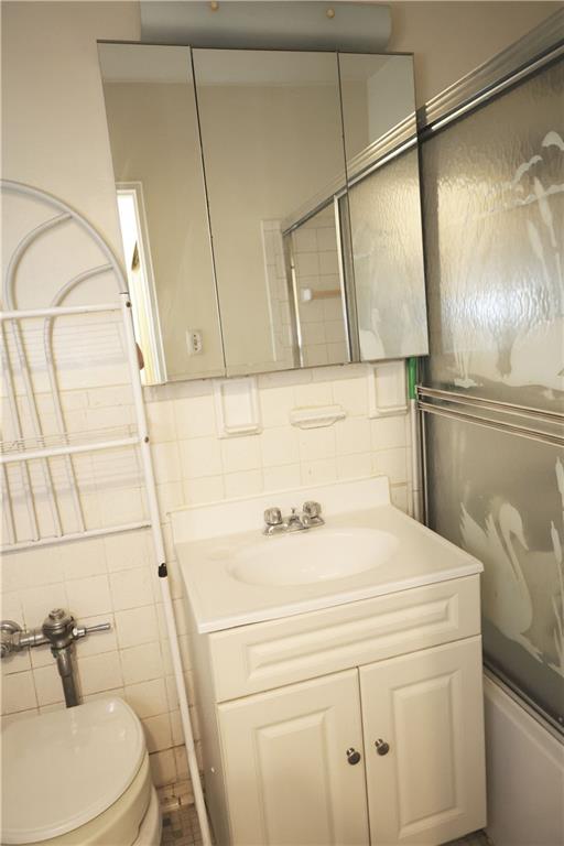 415 Beverley Road, Unit 3J Brooklyn, NY 11218 - Photo 4 of 4 a bathroom with a sink a toilet and shower