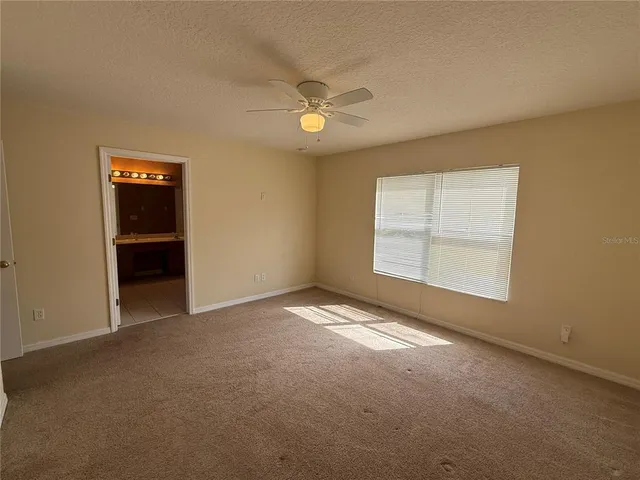 an empty room with a empty space and a ceiling fan