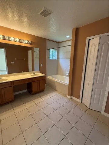 a bathroom with a bathtub and a sink