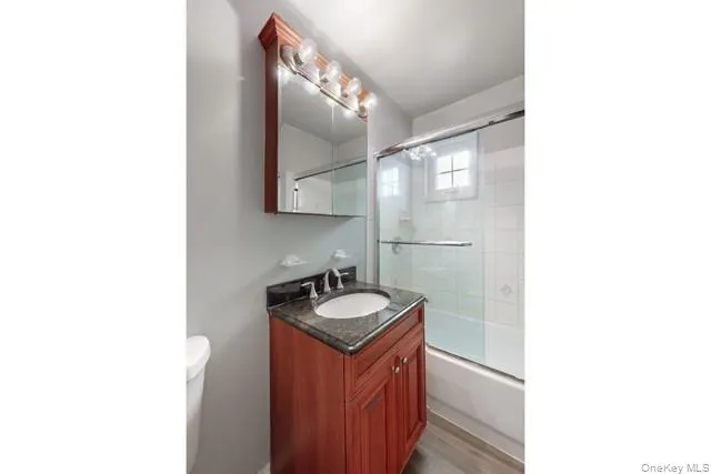 a bathroom with a sink vanity and a mirror