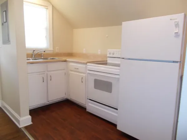 a white refrigerator freezer sitting inside of a kitchen