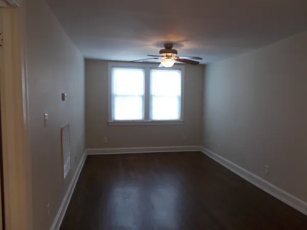 a view of a room with wooden floors and a window